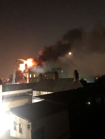 Firefighters tackle a blaze in a block of flats on fire in West Hampstead, London, England, July 26, 2018 in this picture obtained from social media. Hayley Smith/via REUTERS