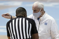 North Carolina head coach Roy Williams speaks with an official during the first half of an NCAA college basketball game against Florida State in Chapel Hill, N.C., Saturday, Feb. 27, 2021. (AP Photo/Gerry Broome)