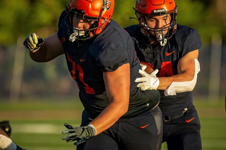 Landon Rapkiewicz (71) leads Phoenix Donghia (24) during FHSAA boys football action as host The Benjamin School Buccaneers take on the Gulliver Prep Raiders in Palm Beach Gardens, Fla., on September 14, 2023.