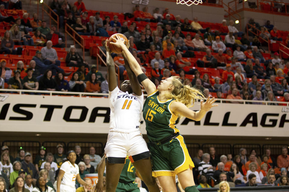 Baylor forward Lauren Cox (15) blocks a shot by Oklahoma State forward Bigue Sarr (11) during the first half of an NCAA college basketball game in Stillwater, Okla., Saturday, Feb. 15, 2020. (AP Photo/Brody Schmidt)