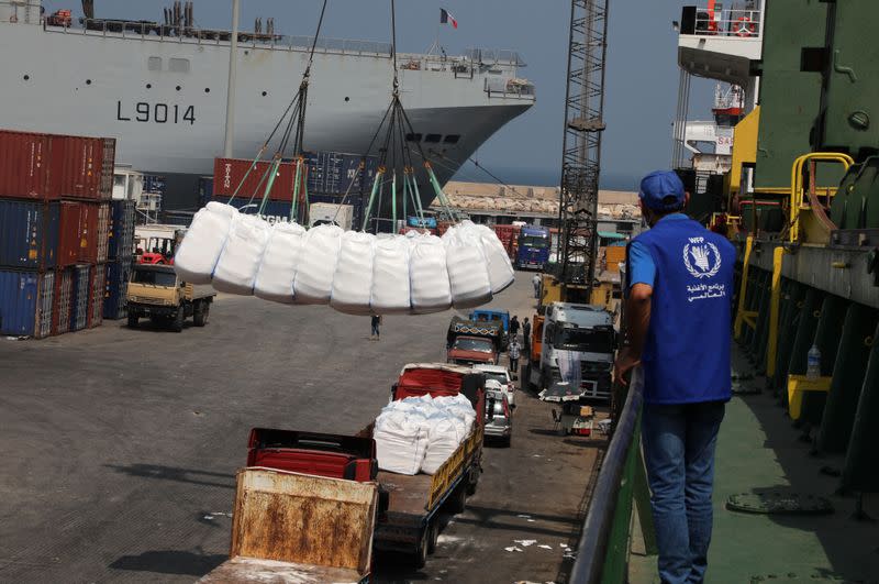 Humanitarian aid donated by World Food Program (WFP), are unloaded at Beirut's port