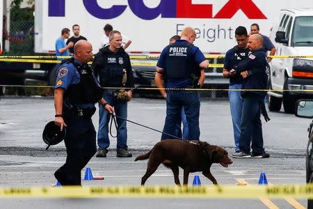 Law enforcement officers mark evidence near the site where Ahmad Khan Rahami, sought in connection with a bombing in New York, was taken into custody in Linden, New Jersey, U.S., September 19, 2016. REUTERS/Eduardo Munoz