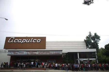 People line up at the entrance of a cinema where the Cuban Otaku festival is taking place in Havana, Cuba, July 24, 2016. REUTERS/Alexandre Meneghini