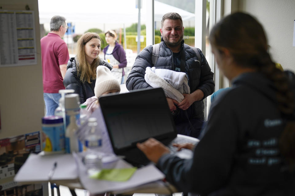 A family from Ukraine arrive to a shelter at the Christian church Calvary San Diego, after crossing into the United States from Tijuana, Mexico, Friday, April 1, 2022, in Chula Vista, Calif. (AP Photo/Gregory Bull)