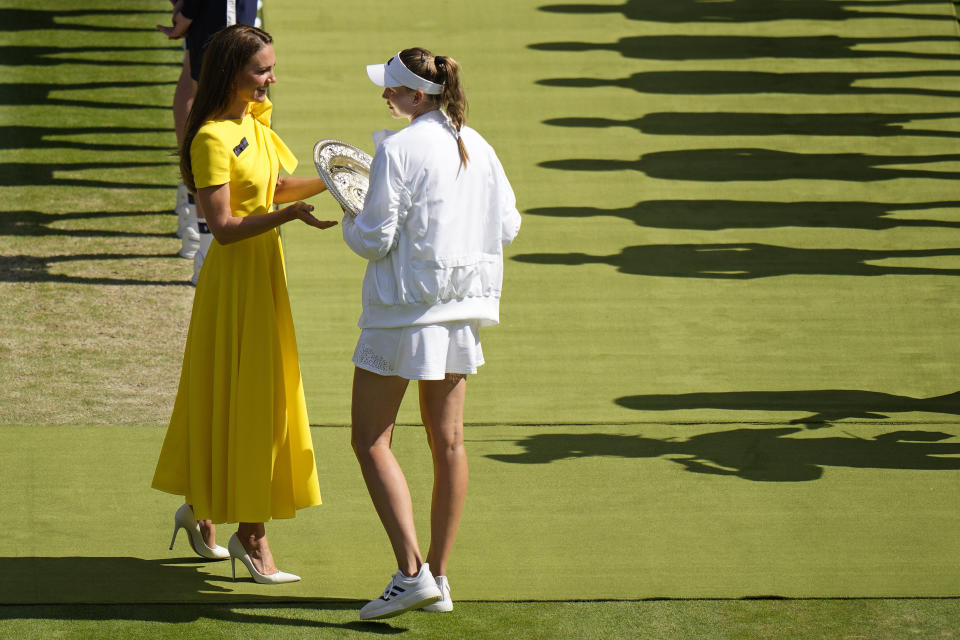 Britain's Kate, Duchess of Cambridge presents the trophy to Kazakhstan's Elena Rybakina after beating Tunisia's Ons Jabeur to win the final of the women's singles on day thirteen of the Wimbledon tennis championships in London, Saturday, July 9, 2022. (AP Photo/Alastair Grant)