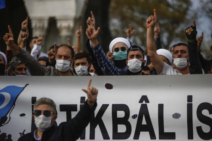 Demonstrators chant slogans during an anti-France protest in Istanbul, Sunday, Oct. 25, 2020. Turkish President Recep Tayyip Erdogan on Sunday challenged the United States to impose sanctions against his country while also launching a second attack on French President Emmanuel Macron. Speaking a day after he suggested Macron needed mental health treatment because of his attitude to Islam and Muslims, which prompted France to recall its ambassador to Ankara, Erdogan took aim at foreign critics. (AP Photo/Emrah Gurel)