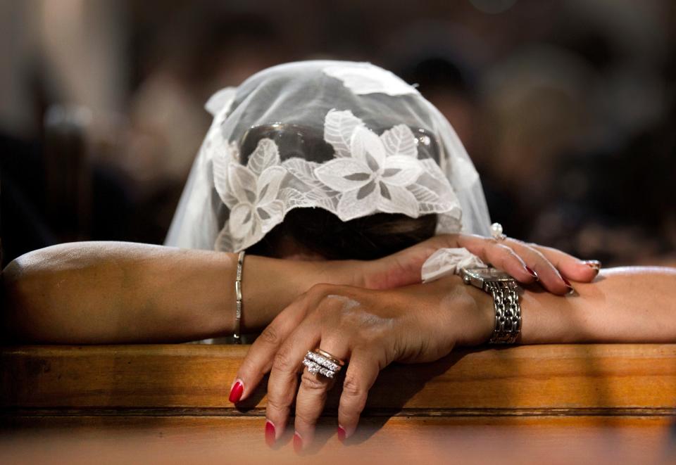 In this Sunday, May 22, 2016 file photo, a woman grieves during prayers for the departed, remembering the victims of the EgyptAir flight 804 crash in Cairo.