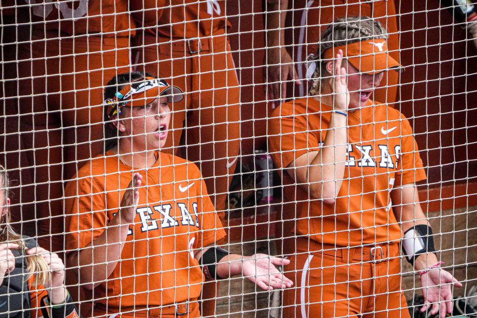 Texas' Lou Gilbert, left, and Ashton Maloney cheer from the dugout during the win over Texas A&M on Sunday. "I think we just need to keep the momentum going and continue to build off of last week," Maloney said.