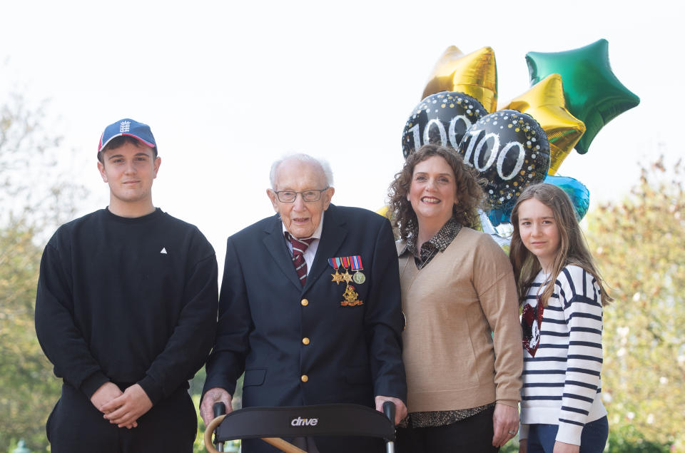 99-year-old war veteran Captain Tom Moore, with (left to right) grandson Benji, daughter Hannah Ingram-Moore and granddaughter Georgia, at his home in Marston Moretaine, Bedfordshire, after he achieved his goal of 100 laps of his garden - raising more than 12 million pounds for the NHS.