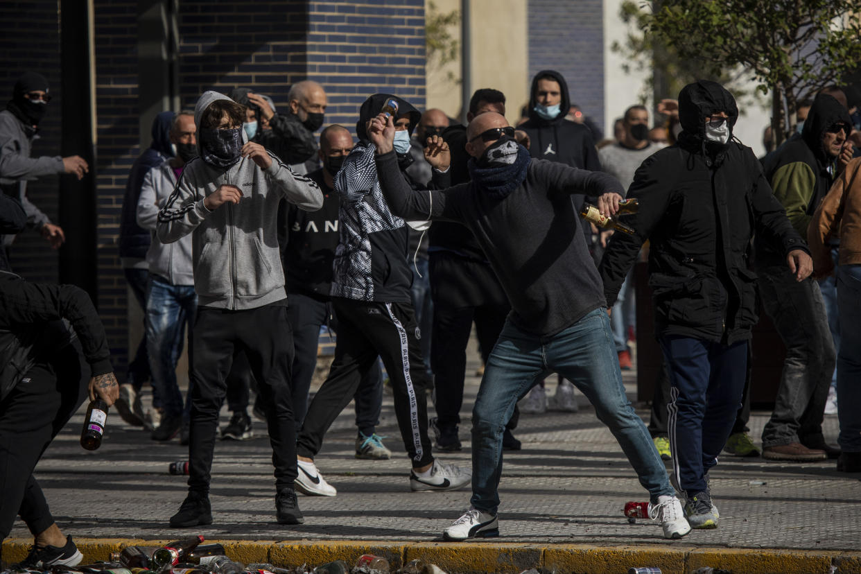 Protesters clash with police forces during a strike organized by metal workers in Cadiz, southern Spain, Tuesday, Nov. 23, 2021. (AP Photo/Javier Fergo)