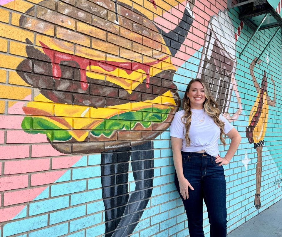 April Henry King poses for a photograph outside her retro mural at Sno-Cap Drive-In in North Augusta on Sunday, Aug. 20, 2023.