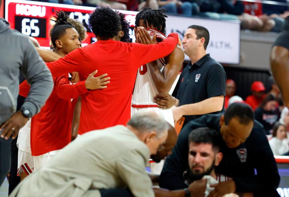 N.C. State’s Terquavion Smith and teammates huddle as Dusan Mahorcic is looked at after he was injured during the second half of N.C. State’s 94-72 victory over Coppin State at Reynolds Coliseum in Raleigh, N.C., Tuesday, Dec. 6, 2022.