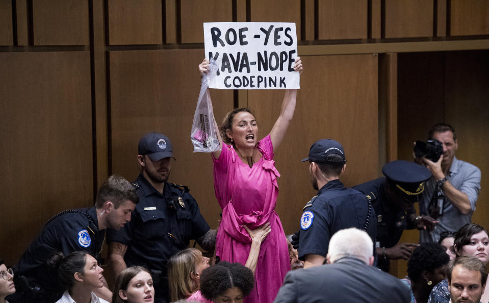 A CodePink protester shouts during Supreme Court nominee Brett Kavanaugh’s confirmation hearing in Washington, D.C., on Tuesday. (Photo By Bill Clark/CQ Roll Call)