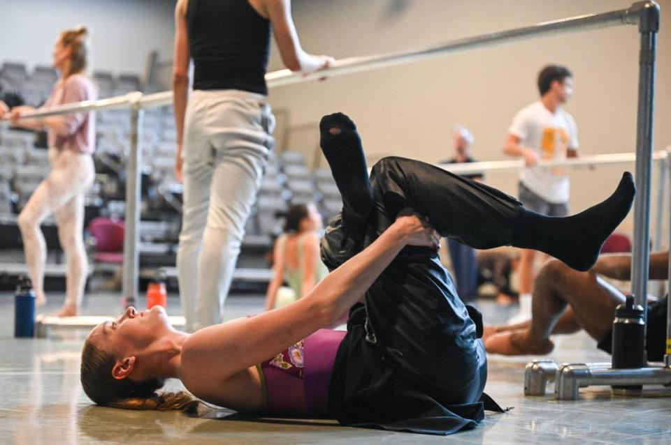 Sarah Lapointe stretches with a modified pigeon pose between barre work in June. Lapointe, 26, has been dancing in one form of another since age 2.