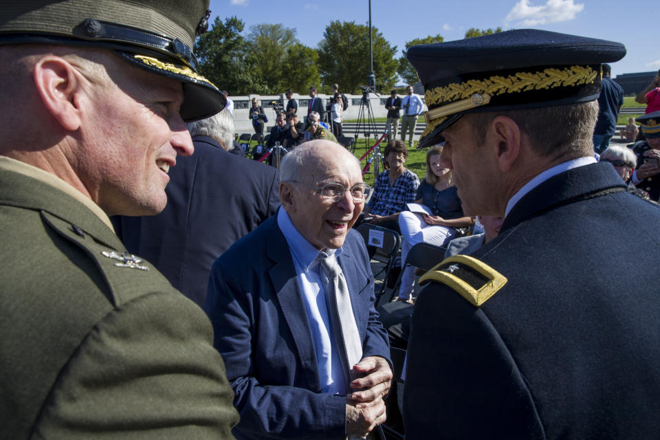 World War II veteran Buck Marsh, center, talks with two active duty military members before a ceremony to present a Bronze Star to Clarence Smoyer, at the World War II Memorial, Wednesday, Sept. 18, 2019, in Washington. (AP Photo/Alex Brandon)