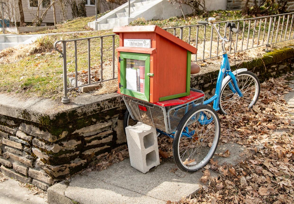 A Little Free Library sits on a three-wheeled bicycle on Coolidge Road.