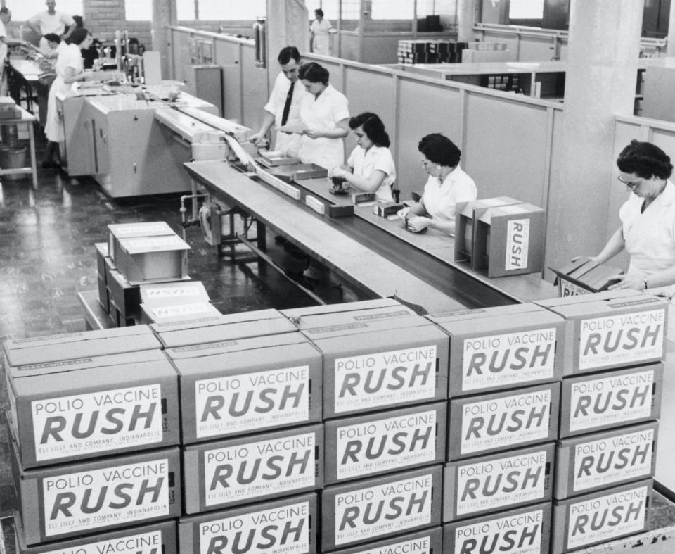 archival photo of packing vials of polio vaccine into boxes