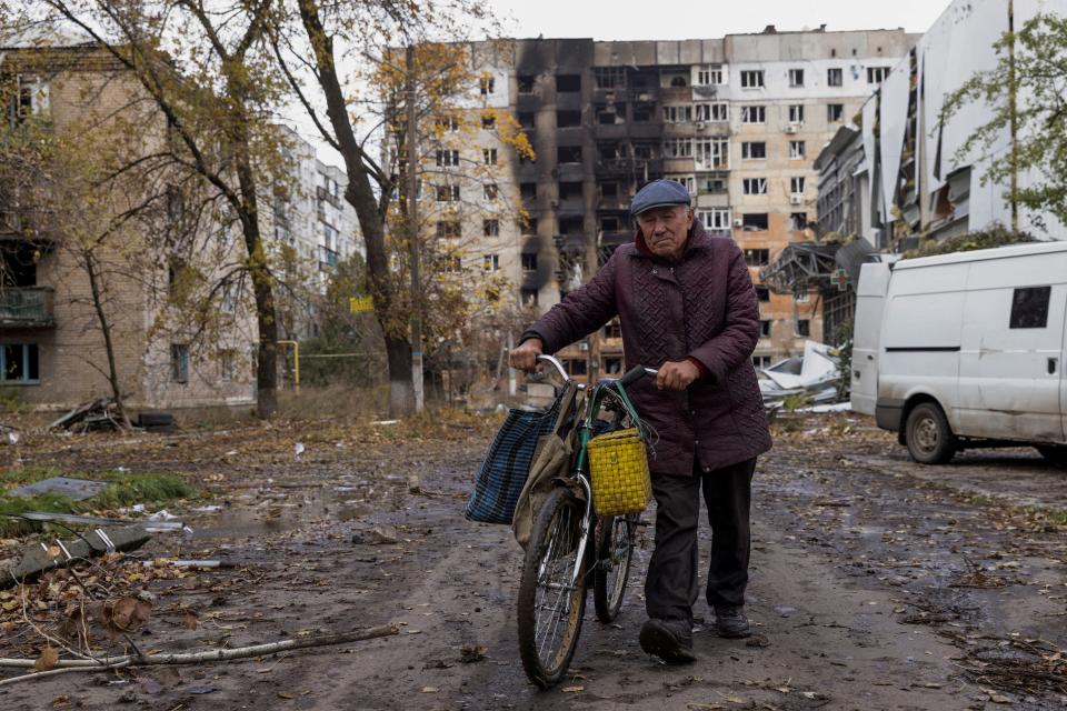 A local resident walks in front of damaged residential buildings in the town of Avdiivka in the Donetsk region this week (REUTERS)