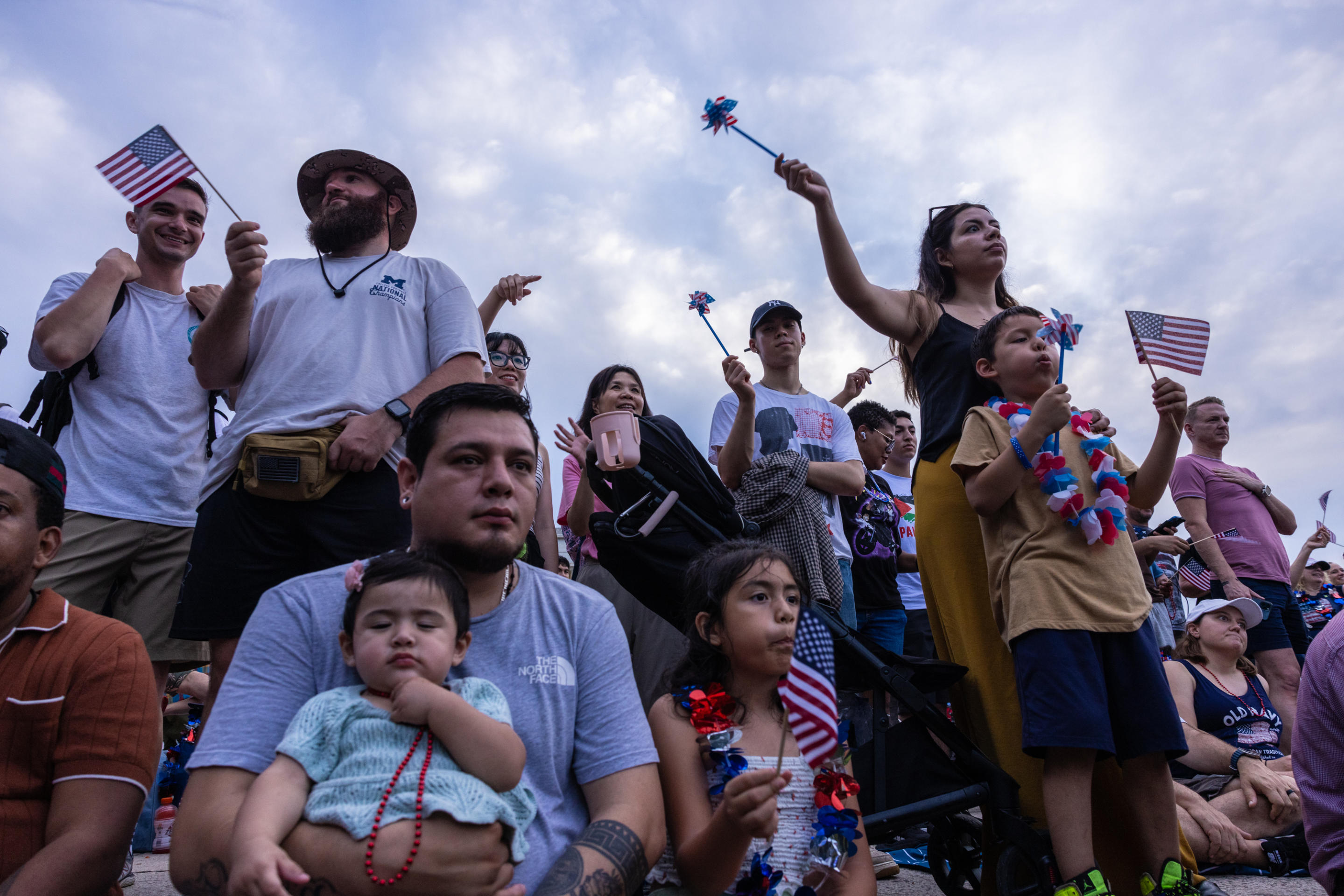 People at the Lincoln Memorial in Washington, D.C., wave flags ahead of the annual fireworks display. 