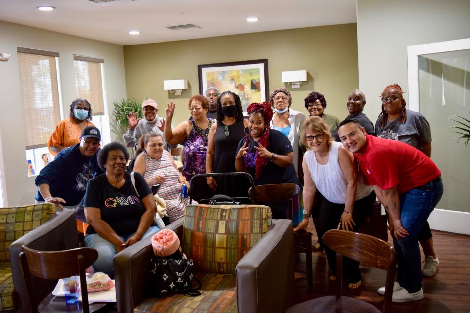 Residents of Grandfamilies Place stand alongside Dana Burns, the founder of A Permanent Voice Foundation, Mary Foxwell, the Assistant Manager of Grandfamilies Place, and Jesus Cruz, the Property Manager of Grandfamilies Place on July 21, 2022.