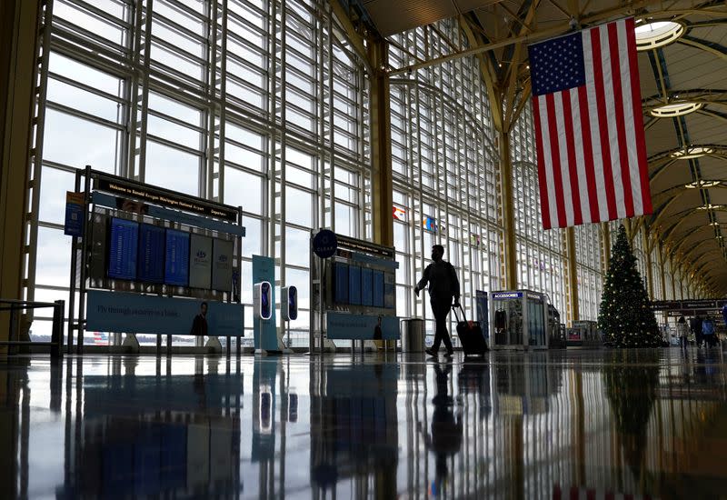 FILE PHOTO: A passenger makes his way through Ronald Reagan Washington National Airport in Arlington, Virginia