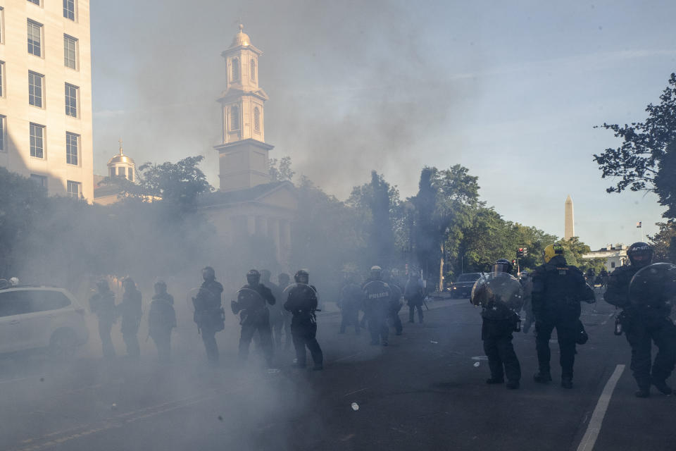 FILE - In this June 1, 2020 file photo police move demonstrators away from St. John's Church across Lafayette Park from the White House, as they gather to protest the death of George Floyd in Washington. Only a few legacy-defining moments have clung to President Donald Trump. But the forceful clearing of demonstrators from the park across from the White House has resonated like few others, sending Trump’s poll numbers tumbling and prompting top military leaders and usually lockstep Republicans to distance themselves from the president. (AP Photo/Alex Brandon, File)