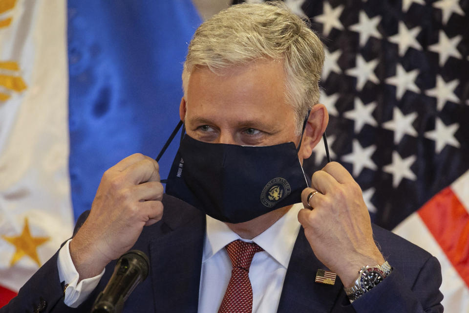 U.S. National Security Advisor Robert O'Brien removes his mask for protection against the coronavirus before speaking at the Department of Foreign Affairs in Pasay City, Philippines Monday, Nov. 23, 2020. (Eloisa Lopez/Pool Photo via AP)