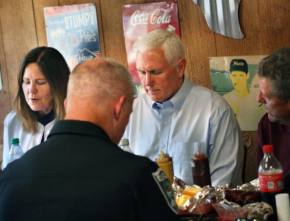 Former Vice President Mike Pence and his wife, Karen, lead a prayer before having lunch at Goody Cole's Smokehouse in Brentwood, N.H., on July 20, 2023.