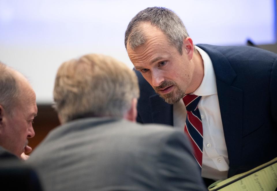 Feb 13 2024; Columbus, Ohio, USA; Montgomery County Assistant Prosecuting Attorney Josh Shaw speaks with Special Prosecutors Tim Merkle and Gary Shroyer in the trial of Michael Jason Meade at the Franklin County Common Pleas Court.