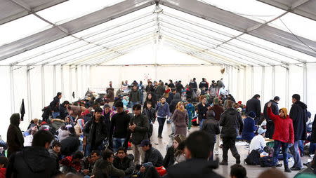 Migrants wait in a tent before passing through the Austrian-German border from Austria, November 12, 2015. REUTERS/Michaela Rehle