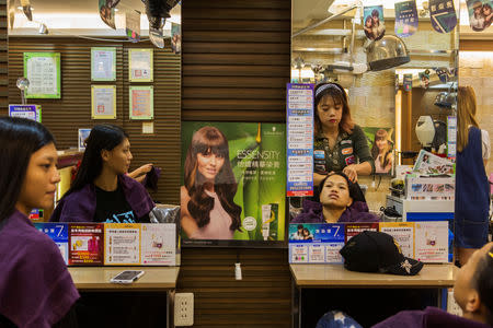 Huang Wensi has her hair done before the match in Taipei, Taiwan, September 26, 2018. REUTERS/Yue Wu