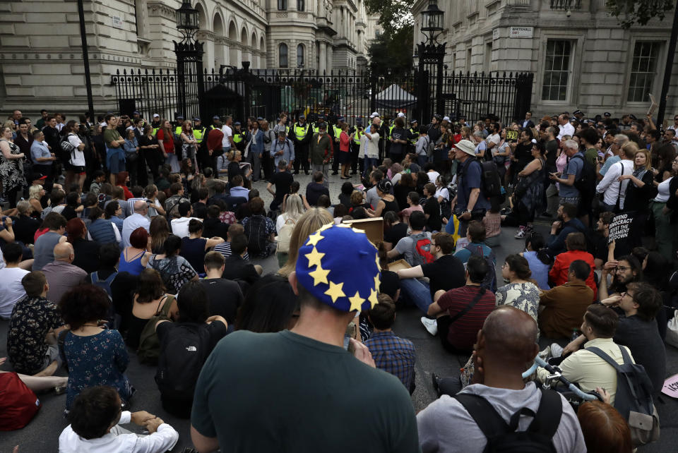 Anti-Brexit supporters gather outside the Prime Minister's residence 10 Downing Street in London, Wednesday, Aug. 28, 2019. British Prime Minister Boris Johnson asked Queen Elizabeth II on Wednesday to suspend Parliament, throwing down the gauntlet to his critics and causing outrage among opposition leaders who will have even less time to thwart a no-deal Brexit. (AP Photo/Matt Dunham)
