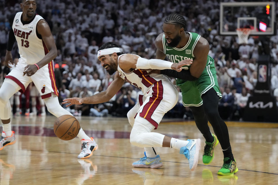 Boston Celtics guard Jaylen Brown (7) defends Miami Heat guard Gabe Vincent (2) during the first half of Game 4 during the NBA basketball playoffs Eastern Conference finals, Tuesday, May 23, 2023, in Miami. (AP Photo/Wilfredo Lee)
