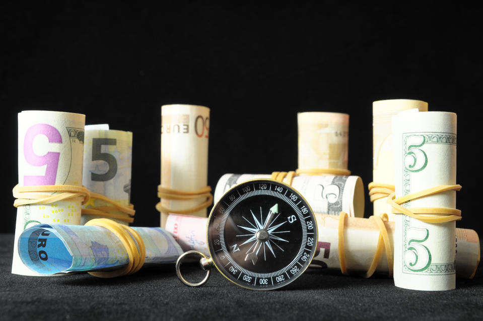 Orientation in Business Compass and Money on a Black Background