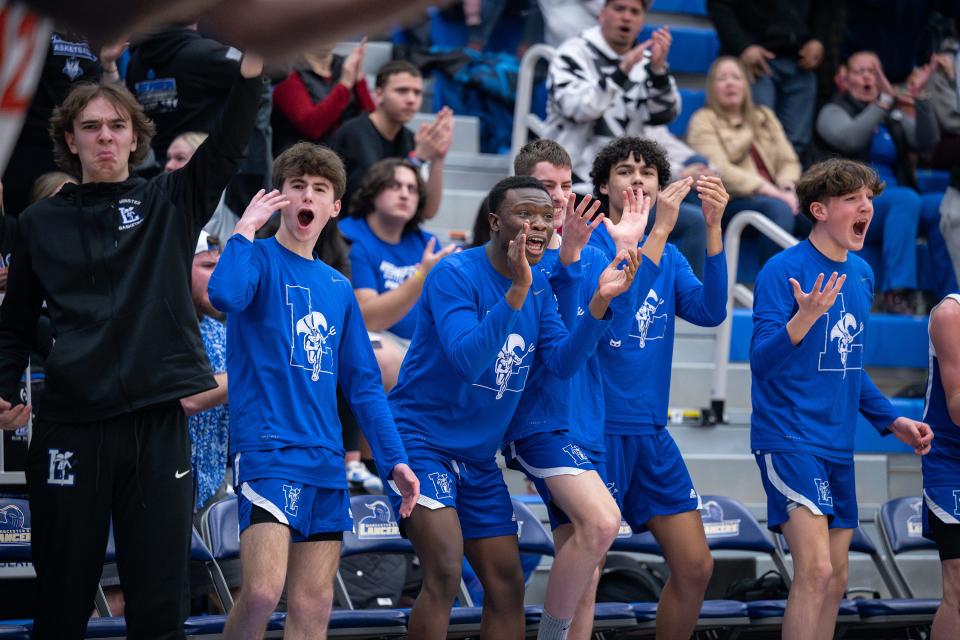 The Leominster bench erupts after the Blue Devils fought back to tie North High in the third quarter during the Central Mass. Class A final.