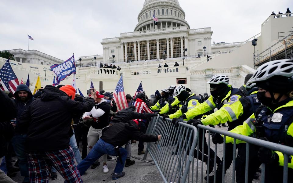 People loyal to then-President Donald Trump, try to break through a police barrier at the Capitol on Jan. 6 2020 - Julio Cortez /AP 