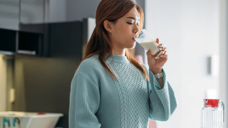 Woman drinking a glass of milk