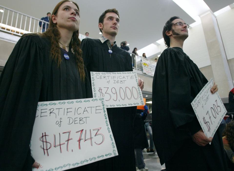 Students holding their 'Certificates of Debt' at graduation. (Bernard Weil/Toronto Star via Getty Images) 