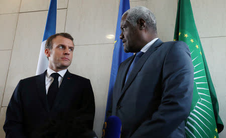 French President Emmanuel Macron talks to African Union Commission Chairperson Moussa Faki Mahamat before addressing a news conference after the meeting at the African Union headquarters in Addis Ababa, Ethiopia March 13, 2019. REUTERS/Tiksa Negeri