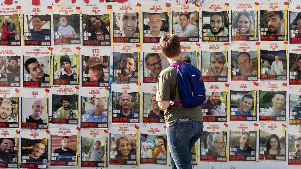 A women looks at photos of hostages held by Hamas in Gaza on May 1, 2024, in Tel Aviv, Israel. - Amir Levy/Getty Images