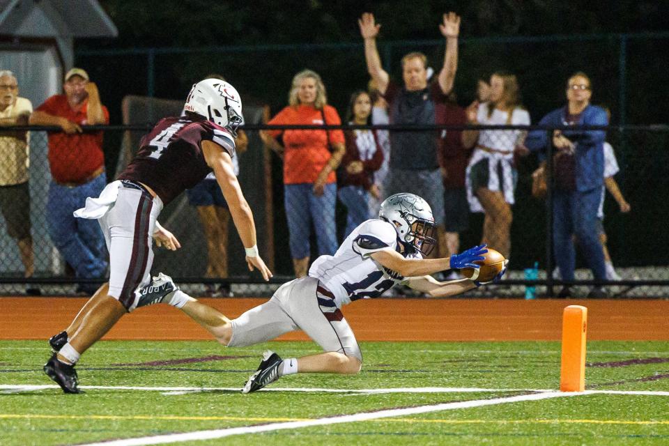 New Oxford's Clayton Nieves (12) launches himself into the endzone for a touchdown during the second half of a football game between the New Oxford Colonials and Gettysburg Warriors, Friday, Sept. 2, 2022, at Warrior Stadium in Gettysburg. The Colonials defeated the Warriors 28-14.