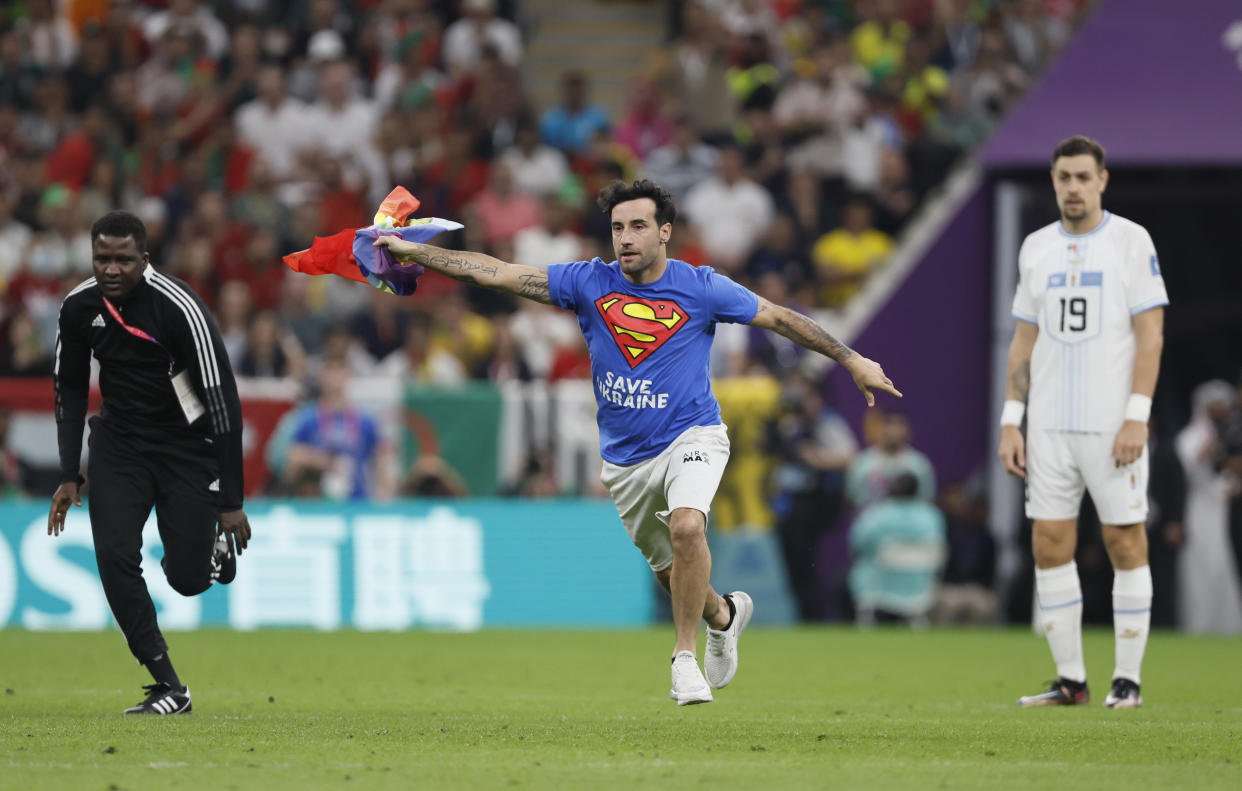 LUSAIL CITY, QATAR - NOVEMBER 28: Fan runs on pitch during the FIFA World Cup Qatar 2022 Group H match between Portugal v Uruguay at Al Janoub Stadium on November 28, 2022 in Lusail City, Qatar. (Photo by Richard Sellers/Getty Images)