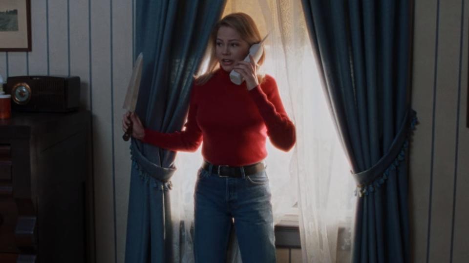 Jen in Dawson's Creek on the phone holding a knife