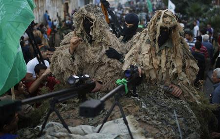 Palestinian Hamas snipers take part in a military parade marking the first anniversary of the eight-day conflict with Israel, in Gaza City November 14, 2013. REUTERS/Mohammed Salem