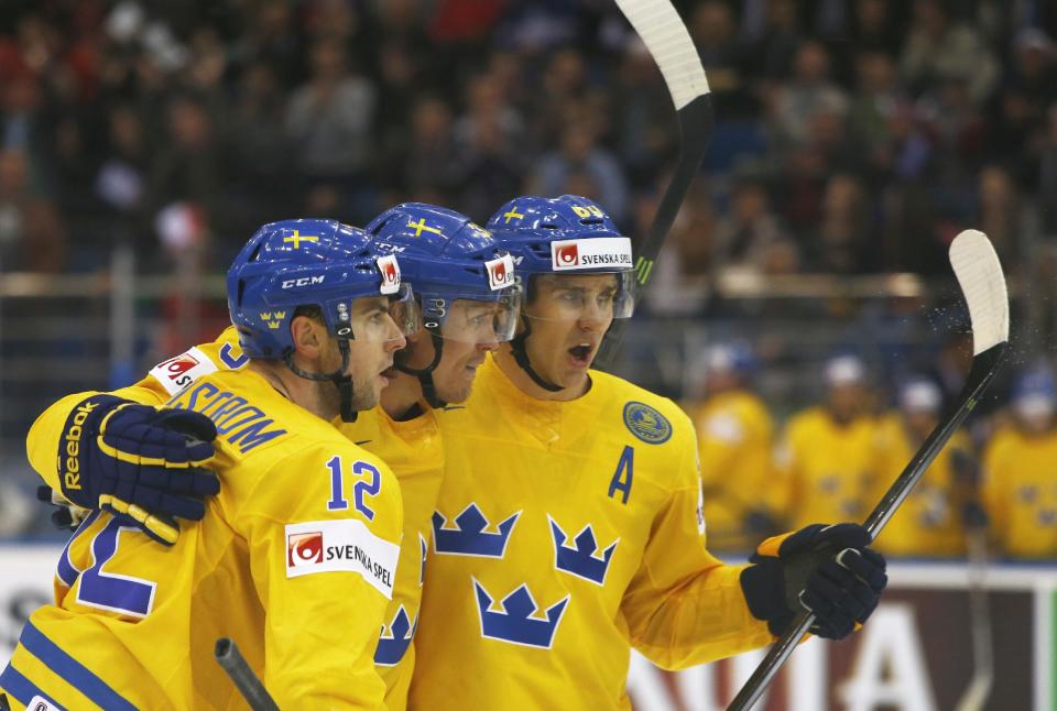 Sweden's players celebrate after Joakim Lindstrom scoring against Norway during the Group A preliminary round match at the Ice Hockey World Championship in Minsk, Belarus, Tuesday, May 13, 2014. (AP Photo/Sergei Grits)