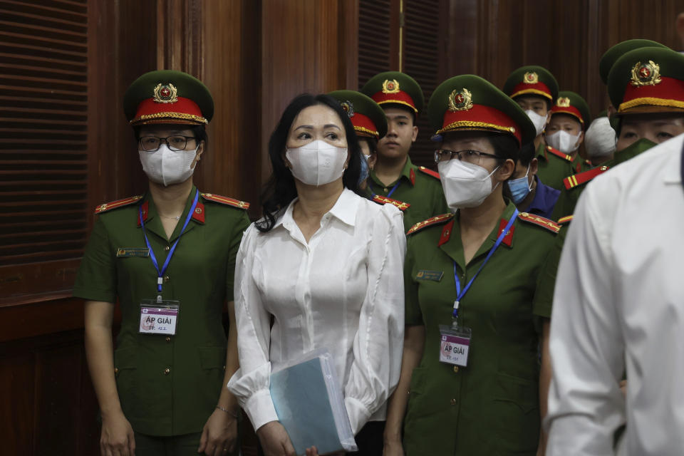 FILE - Vietnamese real estate tycoon Truong My Lan, front center, is escorted into a courtroom in Ho Chi Minh city, Vietnam, on March 5, 2024. Truong My Lan is facing a possible death penalty for allegedly embezzling $12.5 billion. Lan's trial began earlier this month in Ho Chi Minh City. (Phan Thanh Vu/VNA via AP, File)