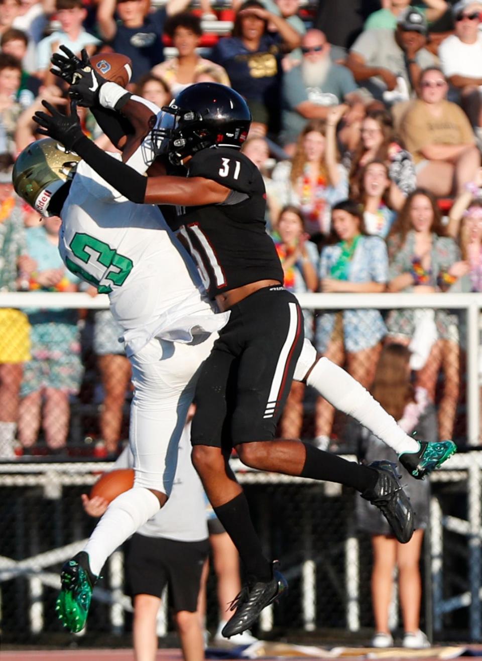 Lafayette Jefferson Bronchos Micah Lillard (31) breaks up a pass intended for Cathedral Fighting Irish wide receiver Jaron Tibbs (13) during the IHSAA football game, Friday, Aug. 19, 2022, at Scheumann Stadium in Lafayette, Ind. 