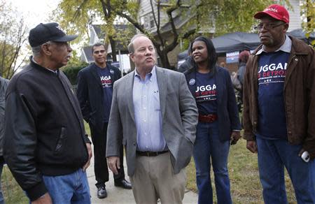 Mayoral candidate Mike Duggan (C) meets with supporters during a campaign stop in his childhood neighborhood in Detroit, Michigan November 2, 2013. REUTERS/Rebecca Cook
