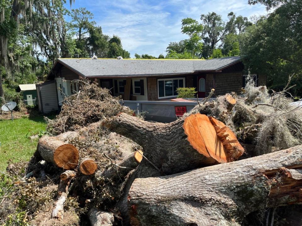 This was the scene on July 1 in front of Chad Taylor and Lisa Anderson's home. Friends are helping them clean up after damage incurred during the June 23 storm that hit Ocala.