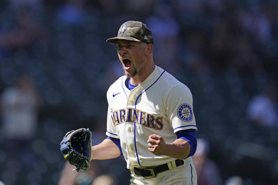 Seattle Mariners relief pitcher Anthony Misiewicz lets out a yell and pumps a fist after a double play with bases loaded ended the top of the seventh inning of a baseball game against the Cleveland Indians Sunday, May 16, 2021, in Seattle. (AP Photo/Elaine Thompson)